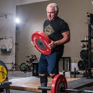 Rudy placing weights on a bar