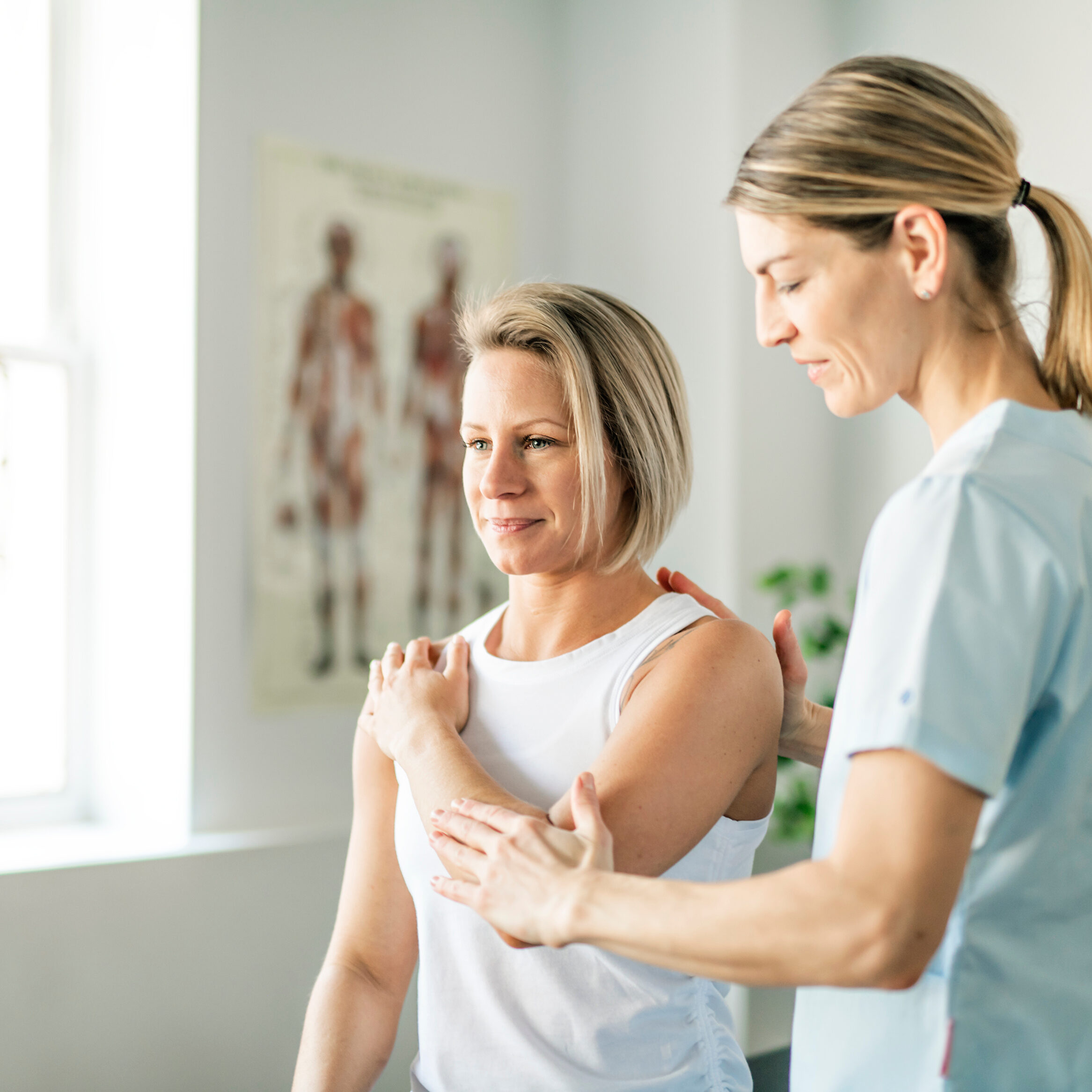 Modern rehabilitation physiotherapy worker with woman suffering from shoulder instability