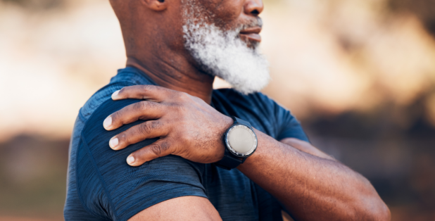An African American man experiences shoulder pain after exercise.