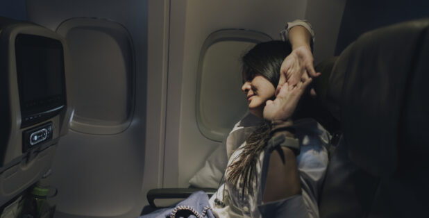 woman stretching on plane