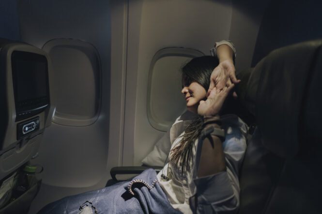 woman stretching on plane