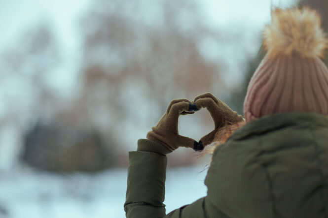 women making a heart with her hands