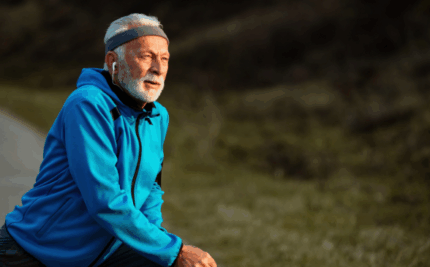 older gentleman stretching before an outdoor workout