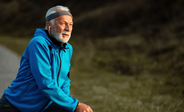 older gentleman stretching before an outdoor workout