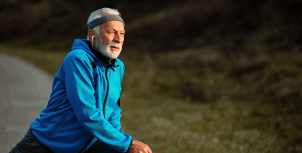 older gentleman stretching before an outdoor workout