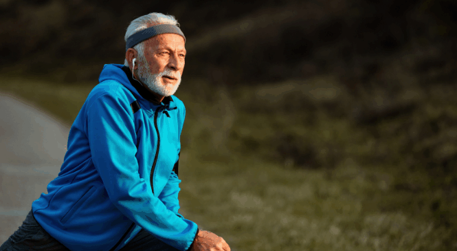 older gentleman stretching before an outdoor workout