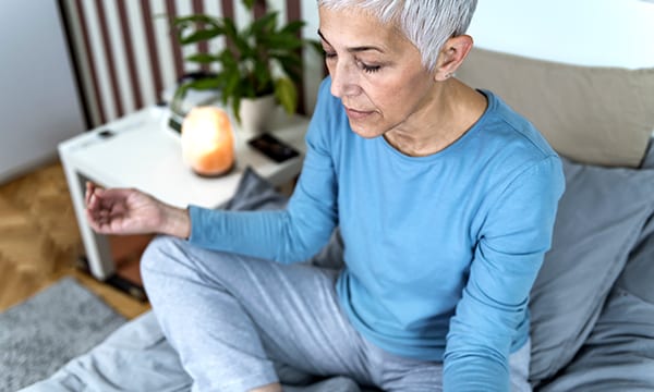 A woman meditating before bed