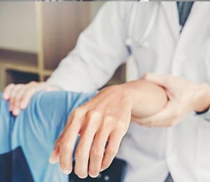 Dr. with a shoulder patient Dr. with a shoulder patient