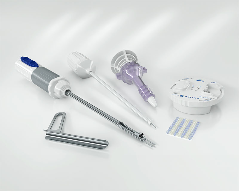 Medical procedure kit containing various surgical instruments including syringes, tubes, clamps, and sterile packaging on white background.